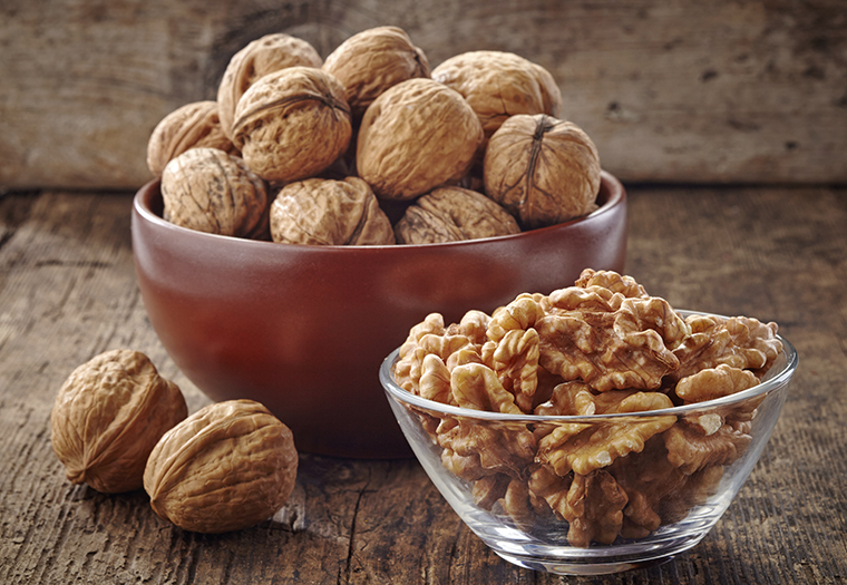 various kinds of walnuts on old wooden table