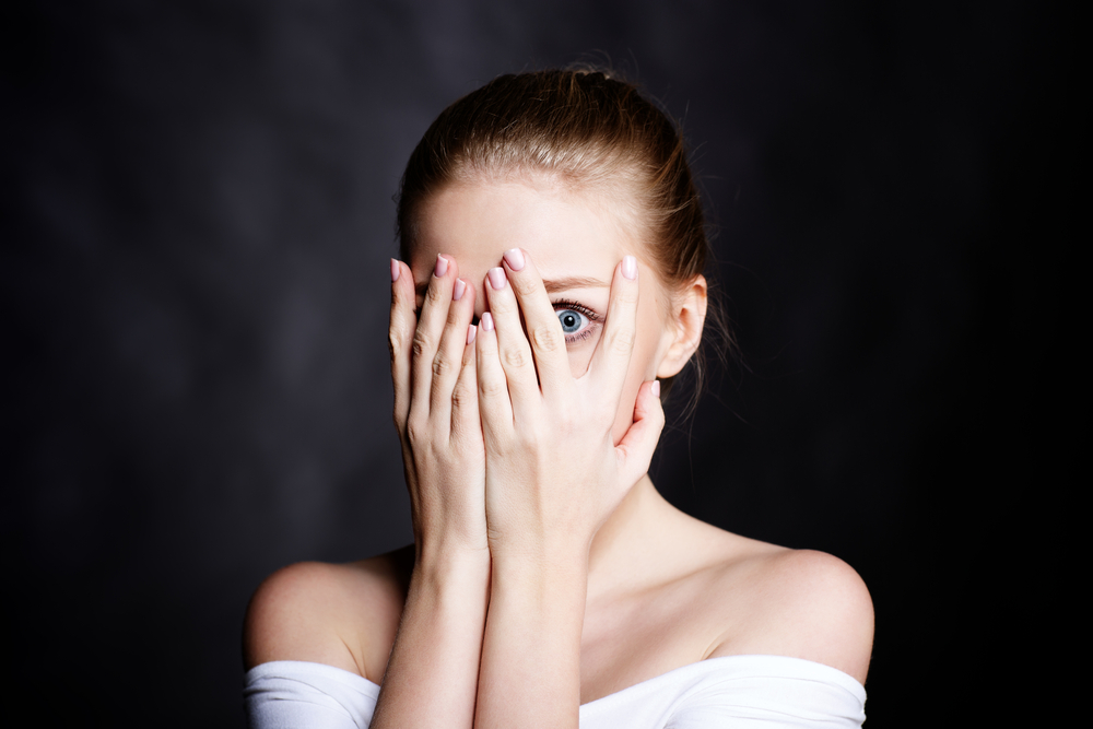 Young,Girl,Covered,Her,Face,With,Fear