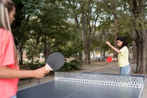close-up-girls-playing-table-tennis-1763549019-821x550