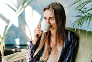magnificent-long-haired-girl-drinking-coffee-with-pleasure-appealing-female-model-enjoying-morning-home-1772001386-821x550