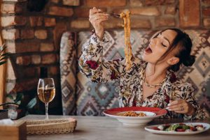 woman-eating-pasta-italian-restaurant-1303-24359-1774934098-821x550