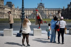 Tourists visit Paris on a sunny spring day