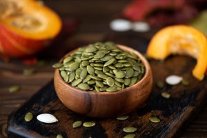 peeled-dried-pumpkin-seeds-wooden-bowl-table-64510526d824f-1789972178-821x550